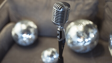 Party podcast, vintage microphone with disco balls in background