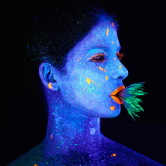 Neon, paint and creative woman in studio with plant for organic art, psychedelic aesthetic or...