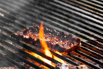 Grilling ribs on a barbecue grill. Close-up.