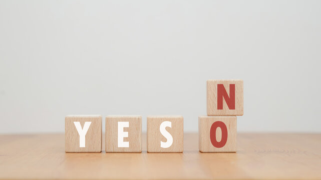 The decision-making concept is represented by a yes no wooden block representing the choice symbol. Think with yes or no options.