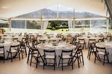 Wedding reception with tables and chairs adorned with white tablecloths