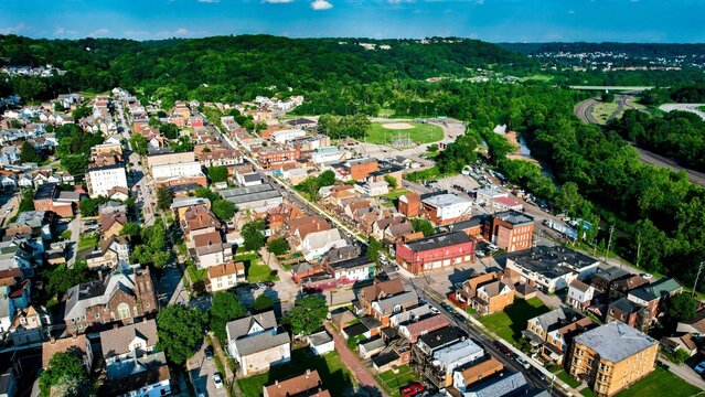 Aerial view of a cityscape featuring rows of residential buildings on either side of the street
