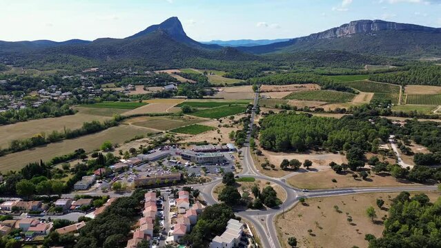 Drone footage over a small village at the foot of Pic Saint-Loup Mountain, France