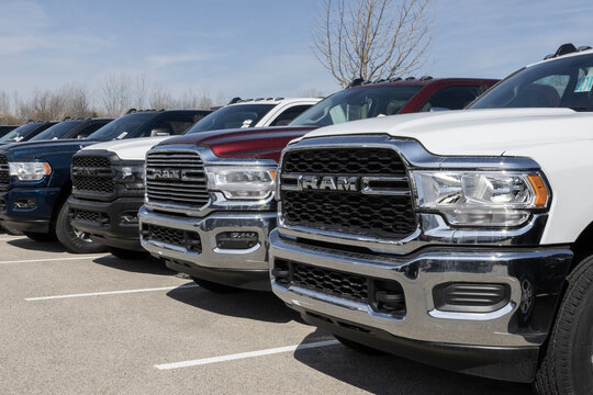 Ram 2500 and 3500 pickup truck display at a dealership. Ram offers the 2500 and 3500 with gas or diesel engines.