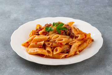 Penne pasta with minced meat and tomato sauce