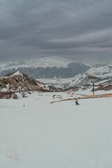 Vertical shot of rocky hills covered in the snow in Ovindoli in Abruzzo, Italy