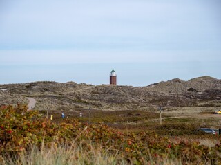 Stunning view of the Leuchtturm Kampen lighthouse, on the island of Sylt in Germany - obrazy, fototapety, plakaty