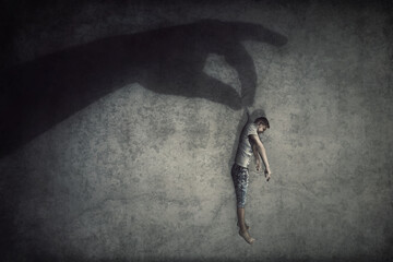 Human manipulation concept as a big hand shadow holds a powerless man hanging down as a marionette. People control supremacy and dominance metaphor