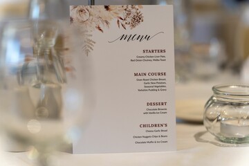 Elegant white plate with a wedding menu displayed prominently atop, resting on a bright background