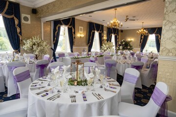 Empty wedding reception area set up with tables, ready for guests to arrive