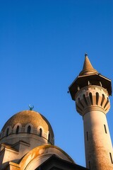 Low-angle shot of the Carol I Mosque in Constanta, Romania against a blue sky