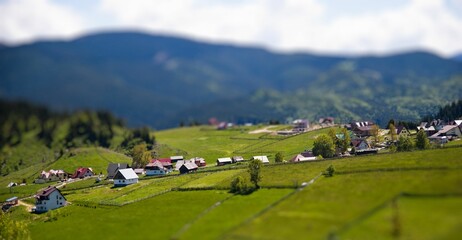Fototapeta na wymiar Scenic view of rural houses in green hills in Fundata, Romania