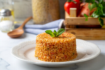 Traditional turkish bulgur pilaf with tomato sause in plate (Turkish name; meyhane pilavi)