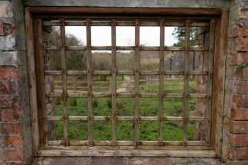 Fototapeta na wymiar Closeup shot of an old wooden grid in a window.