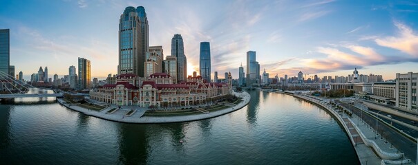 Aerial shot of an urban skyline with landmarks along the Haihe River in Tianjin, China at sunset - obrazy, fototapety, plakaty
