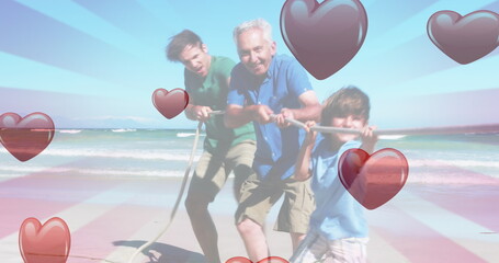 Image of hearts falling over caucasian family at beach