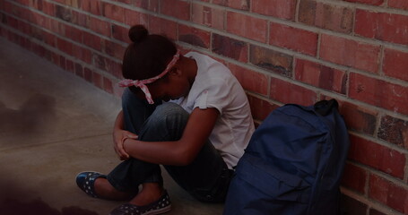 Image of black clouds over sad african american schoolgirl