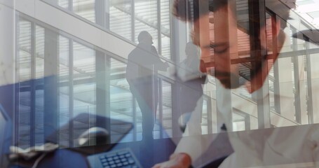 Image of talking business people over men using laptop