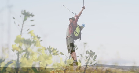 Image of meadow over caucasian man with arms outstretched hiking