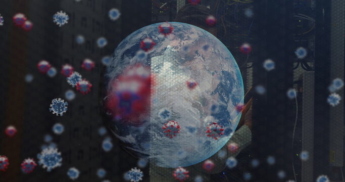 Image of virus cells and globe over caucasian male worker in server room