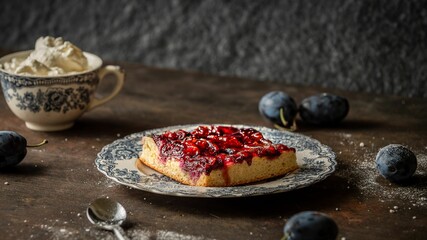 Delicious homemade plum cake with a spelt flour base on a wooden table