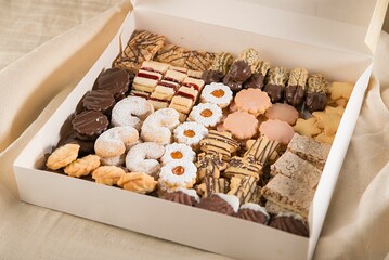 Box of assorted snacks and treats open on a table perfect for Christmas