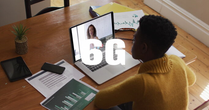 Image of 6g text and white particles over african american woman having a image call on laptop
