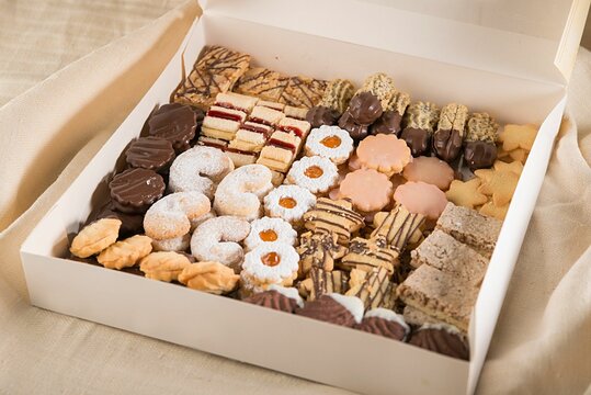 Box of assorted snacks and treats open on a table perfect for Christmas