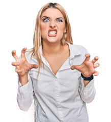 Young caucasian woman wearing casual clothes smiling funny doing claw gesture as cat, aggressive...