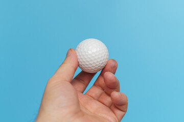 Man hand holding golf ball with fingers