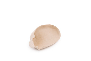 A beige bread-shaped object, the inner shape of a cardboard shoe, so as not to lose the shape of the shoe, on a white background.