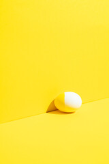 Yellow painted easter egg on yellow background