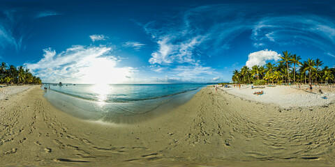 Beautiful 360 degree panorama at the beach of Trou Aux Biches Mauritius at sunset with a lot of  people walking and laying on the beach.