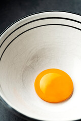 Egg yolk in a white ceramic bowl