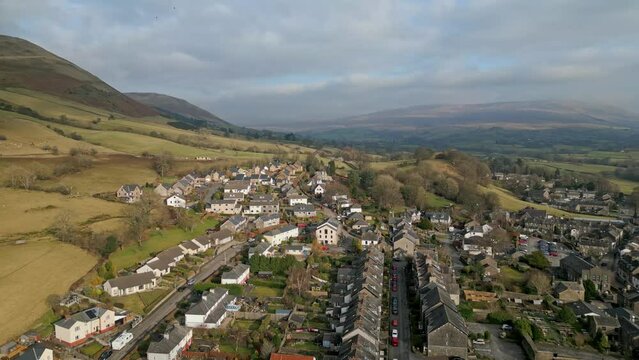 Drone landscape with view of Sedbergh town with rural houses near green hills