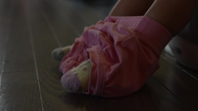 Toddler girl potty training - close up on feet on edge of potty