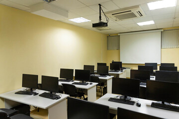 Empty classroom, school auditorium with chalkboard and computers on the desk. Education concept.