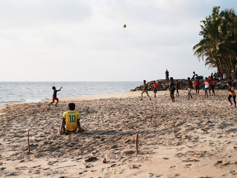 children playing football on the beach