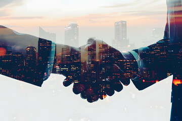 Hand of businessman handshake in a silhouette double exposure. in the background is view of city, talk about planning in business and investment