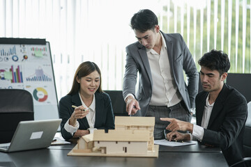 Asian business presents to explain the graph work on the whiteboard. Consulting, discussing, exchanging knowledge.