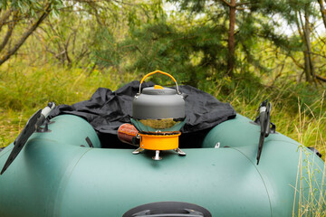 Tourist kettle on a gas burner. Cooking in field conditions. Using a tourist gas burner