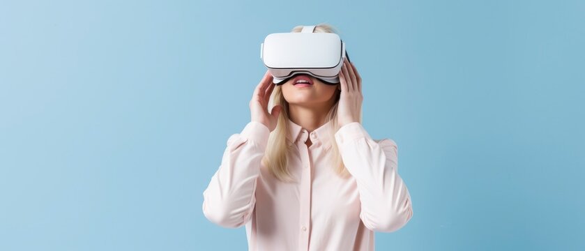 Young woman using virtual reality headset on plain background
