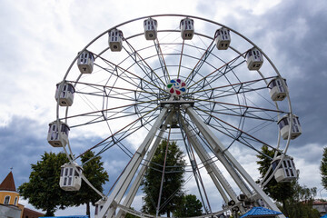 Fototapeta premium Ferris wheel ride in a public park. The concept of entertainment, recreation and travel.