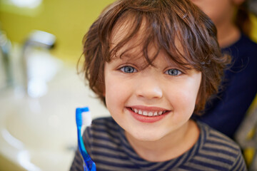 Boy, portrait or child in home brushing teeth with smile for development morning routine in...