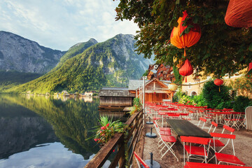 Summer cafe on the beautiful lake between mountains. Alps. Halls