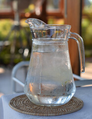 Cold water in glass pitcher