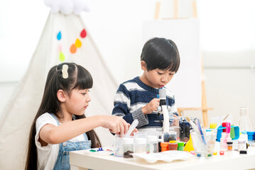 young boy and girl learning test science at home school