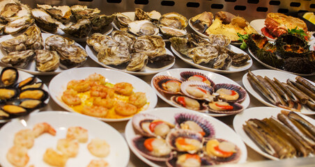 a table full of plates of oysters and oysters