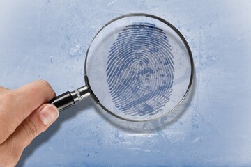 Magnifier with fingerprint.  Background of crime, detective, bio metric concept
