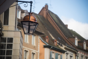 closeup of vintage street light on historic building facade background in Mulhouse - France - 768012873